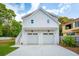 A modern two-car garage with a staircase on the side and a light-colored driveway at 362 6Th Ave, Mount Pleasant, SC 29464