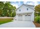 Two car garage with speckled driveway and stairs to second level at 362 6Th Ave, Mount Pleasant, SC 29464