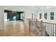 Open hallway with hardwood floors and a dramatic light fixture at 362 6Th Ave, Mount Pleasant, SC 29464