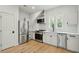 Bright kitchen with stainless steel appliances, white cabinets, and light wood floors at 362 6Th Ave, Mount Pleasant, SC 29464
