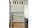 White kitchen cabinets, light tile backsplash, and hardwood floors at 362 6Th Ave, Mount Pleasant, SC 29464