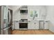 Bright kitchen with stainless steel appliances, white cabinets, and light wood floors at 362 6Th Ave, Mount Pleasant, SC 29464