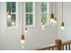 Modern gold and glass pendant lights above the stairwell at 362 6Th Ave, Mount Pleasant, SC 29464
