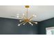 Close-up shot of a modern gold chandelier, showcasing its unique design and the warm ambiance it creates at 362 6Th Ave, Mount Pleasant, SC 29464