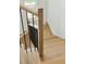 Close-up of a modern staircase with light wood steps and black metal railings, highlighting the craftsmanship and design at 362 6Th Ave, Mount Pleasant, SC 29464
