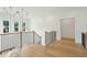 Bright hallway with hardwood floors and a stylish light fixture at 362 6Th Ave, Mount Pleasant, SC 29464