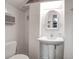 Small bathroom with pedestal sink, toilet, and white wicker mirror at 363 Clayton Dr, Charleston, SC 29414