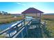 Wooden dock with gazebo, floating boat slip, and tranquil marsh views at 363 Clayton Dr, Charleston, SC 29414