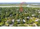 Aerial view showcasing a house surrounded by trees, with a waterfront in the distance at 420 E Erie Ave, Folly Beach, SC 29439