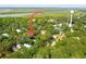 Aerial view of a house near the water, with tennis courts and other houses nearby at 420 E Erie Ave, Folly Beach, SC 29439