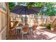 Outdoor patio with table and chairs, shaded by an umbrella at 420 E Erie Ave, Folly Beach, SC 29439