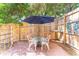 Relaxing backyard patio with table and chairs under umbrella at 420 E Erie Ave, Folly Beach, SC 29439