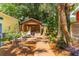 Landscaped backyard with a wooden pergola, creating a peaceful outdoor space at 420 E Erie Ave, Folly Beach, SC 29439