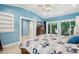 Bright bedroom with blue walls, patterned bedding, and access to a private patio at 420 E Erie Ave, Folly Beach, SC 29439