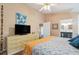 Main bedroom with king bed, dresser, and view of bathroom at 420 E Erie Ave, Folly Beach, SC 29439