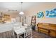 Charming dining area with white table and piano adjacent to kitchen at 420 E Erie Ave, Folly Beach, SC 29439