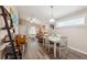 Open concept dining area with white table and chairs near living room at 420 E Erie Ave, Folly Beach, SC 29439