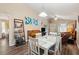 Bright dining area with white table and chairs, adjacent to living room at 420 E Erie Ave, Folly Beach, SC 29439