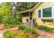Yellow cottage with brick walkway, landscaping, and awning at 420 E Erie Ave, Folly Beach, SC 29439