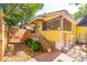 Yellow cottage with hammock, deck, and tropical landscaping at 420 E Erie Ave, Folly Beach, SC 29439