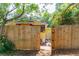 Wooden fence with decorative gate and access to backyard at 420 E Erie Ave, Folly Beach, SC 29439