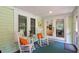 Front porch with rocking chairs, view into the kitchen at 420 E Erie Ave, Folly Beach, SC 29439