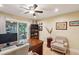 Bright home office features built-in shelving, hardwood floors, and access to a private deck at 420 E Erie Ave, Folly Beach, SC 29439