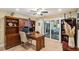 Home office with hardwood floors, built-in shelving, and a view of the back patio at 420 E Erie Ave, Folly Beach, SC 29439