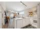 Open concept kitchen features white cabinets and a view into the living room at 420 E Erie Ave, Folly Beach, SC 29439