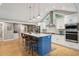 Modern kitchen with blue island and stainless steel appliances at 420 E Erie Ave, Folly Beach, SC 29439