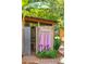 Private outdoor shower with wooden walls and pink towels at 420 E Erie Ave, Folly Beach, SC 29439