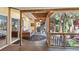 Relaxing screened porch with wicker seating, creating a cozy outdoor space at 420 E Erie Ave, Folly Beach, SC 29439