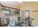 Relaxing screened porch with glass-top table and seating at 420 E Erie Ave, Folly Beach, SC 29439