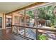 Screened porch with stairs leading to a backyard patio and lush landscaping at 420 E Erie Ave, Folly Beach, SC 29439