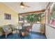 Cozy screened porch with glass-top table and seating at 420 E Erie Ave, Folly Beach, SC 29439