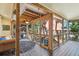 Screened porch offers outdoor seating and lush tropical views at 420 E Erie Ave, Folly Beach, SC 29439
