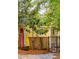 Yellow cottage with surfboards, landscaping, and black metal gate at 420 E Erie Ave, Folly Beach, SC 29439