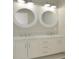 Elegant double vanity bathroom with round mirrors and marble countertop at 488 Society Rd, McClellanville, SC 29458
