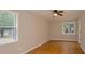 Hardwood floor bedroom with neutral walls and large windows at 488 Society Rd, McClellanville, SC 29458