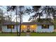 Newly renovated ranch home with white brick exterior, covered porch, and landscaping at 488 Society Rd, McClellanville, SC 29458