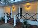 Charming front porch with black metal railings and modern lighting at 488 Society Rd, McClellanville, SC 29458