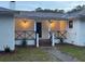 Inviting front porch features brick steps and stylish black railings at 488 Society Rd, McClellanville, SC 29458