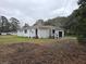 White brick ranch house with attached garage at 488 Society Rd, McClellanville, SC 29458