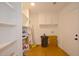 Functional laundry room with built-in shelving and hardwood floors at 488 Society Rd, McClellanville, SC 29458
