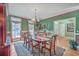 Elegant dining room features a large table, hardwood floors, and decorative wallpaper at 560 Barfield Dr, Summerville, SC 29485