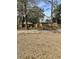 Backyard featuring a wood fence, mature trees and partial view of an external utility box at 611 Resinwood Rd, Moncks Corner, SC 29461
