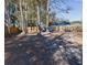 Large backyard with mature trees and wooden fence at 611 Resinwood Rd, Moncks Corner, SC 29461