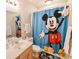 Clean bathroom with Mickey Mouse theme shower curtain at 611 Resinwood Rd, Moncks Corner, SC 29461
