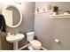 Small bathroom with pedestal sink, toilet, and decorative shelves at 611 Resinwood Rd, Moncks Corner, SC 29461