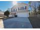 Two-story house with beige siding, white garage door, and a porch at 611 Resinwood Rd, Moncks Corner, SC 29461